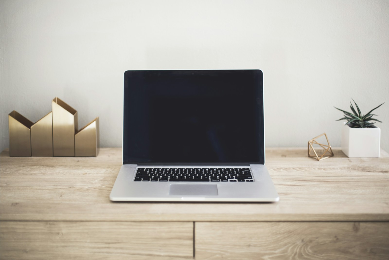 Laptop on a simple desk in natural light